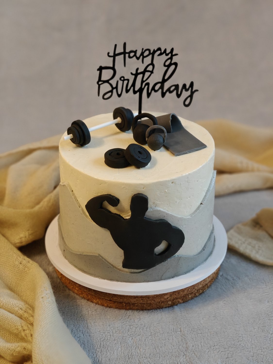 Two-tier fitness themed cake with fondant muscleman silhouette